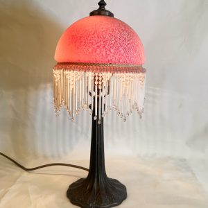 A Vintage Victorian Boudoir Lamp With A Frosted Glass Dome And Beaded Fringe